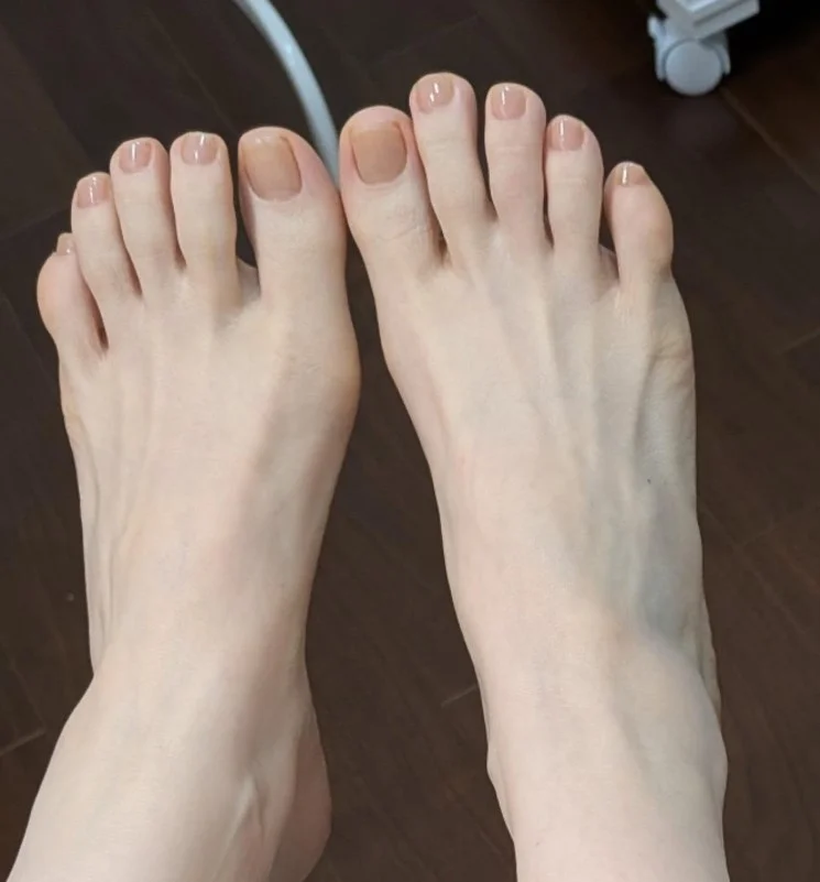 Barely-there beige toenails with a polished neutral finish