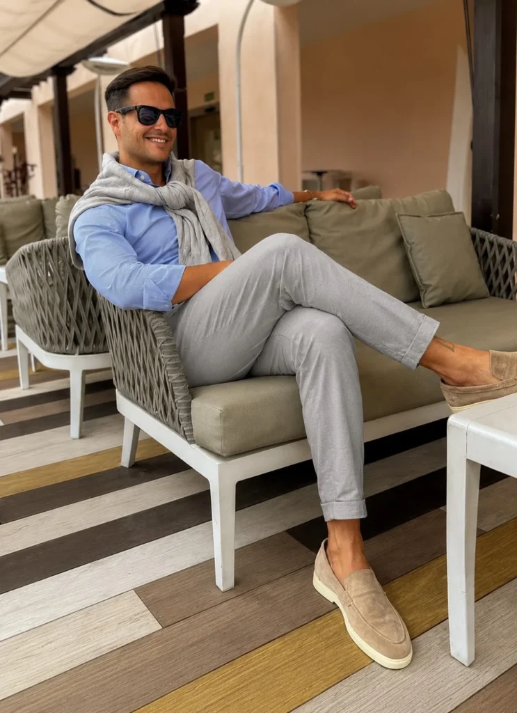 Beige suede loafers paired with light grey linen trousers for summer fashion.