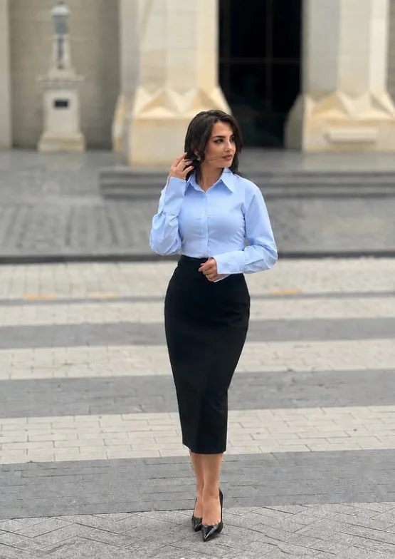 Blue button down shirt with a black midi skirt