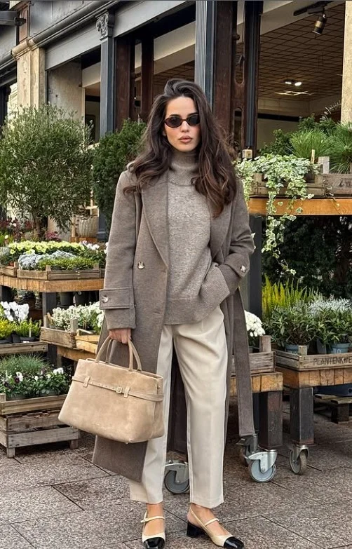 Camel beige coat styled with cream clothing for an elegant everyday outfit.