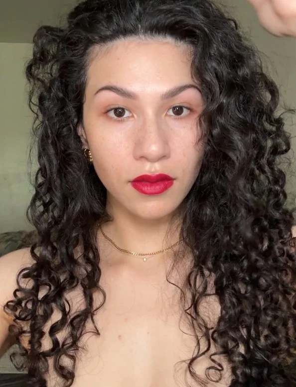 Classic blue-red lipstick creating elegant contrast on fair skin.