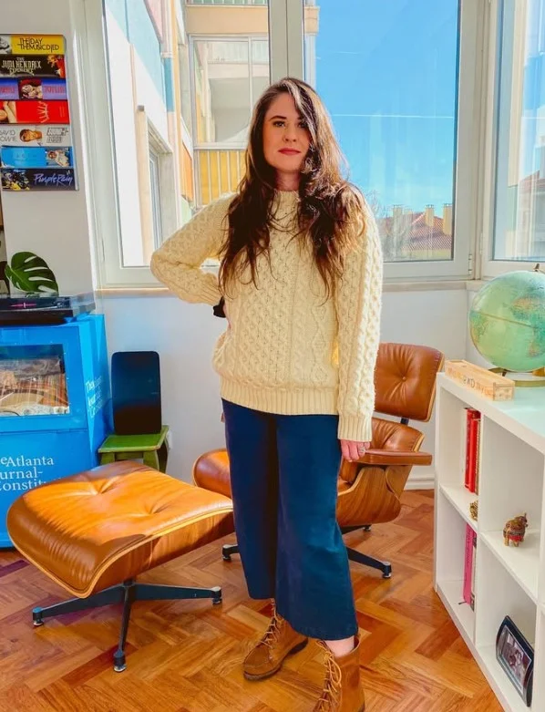 Dark jeans with cream sweater and brown leather boots