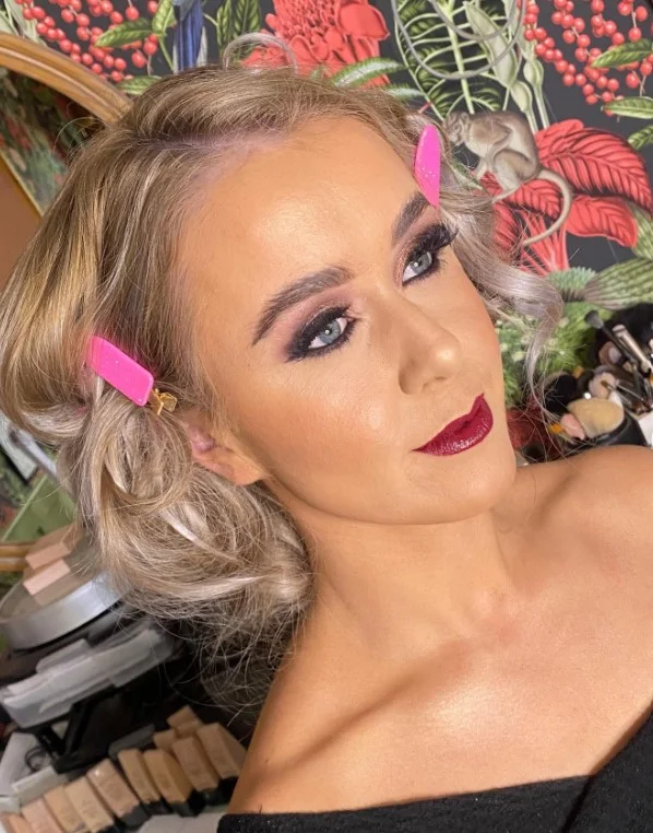 Deep wine lipstick creating a bold elegant look on fair skin.