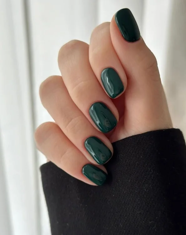 Emerald green nail varnish with glossy salon-style shine.
