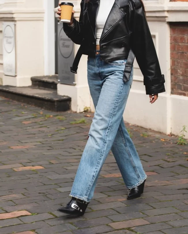 Straight-leg jeans with black ankle boots and a fall sweater