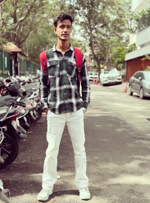 Green flannel shirt with cream trousers and brown shoes