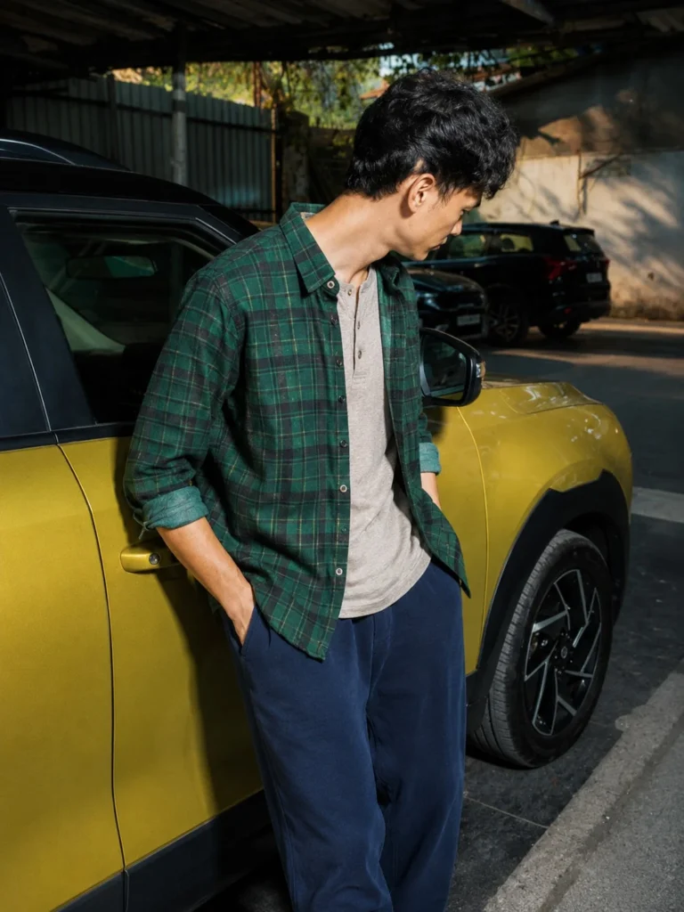 Green flannel worn open over a cream Henley and jeans