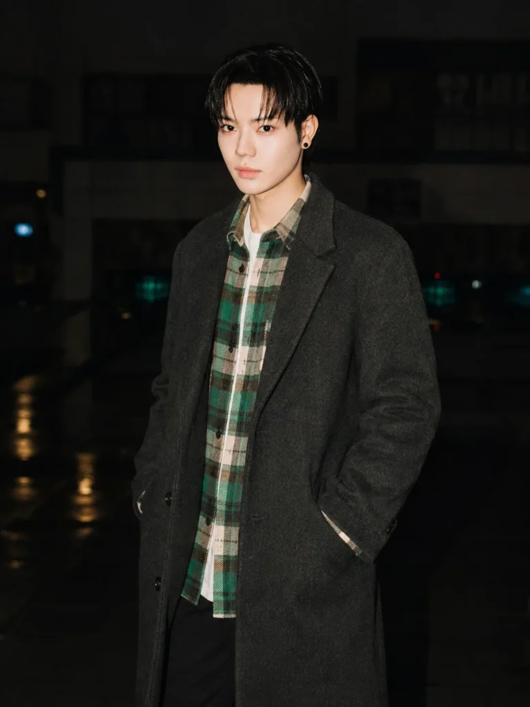 Green flannel layered under a wool coat for winter