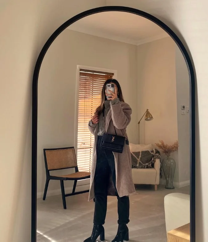High-waisted jeans with heeled boots and a fall jacket