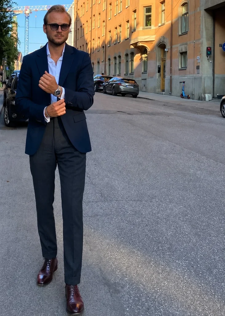 Oxblood leather dress shoes matched with charcoal grey tailored trousers.