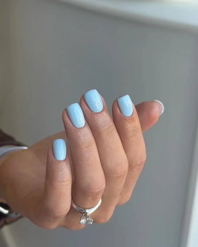 Powder blue nails styled with a clean minimalist manicure.