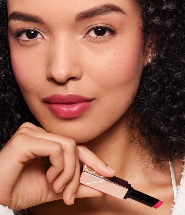 Raspberry pink lipstick adding vibrant color to fair complexion.