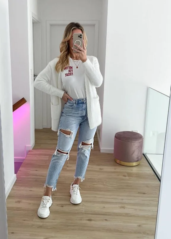 Woman in relaxed light-wash jeans with a simple tee and clean white sneakers