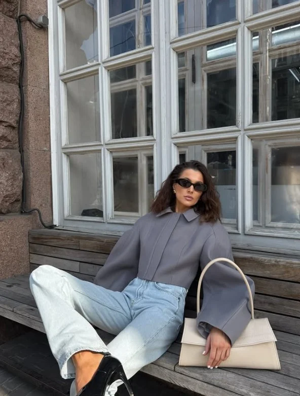 Woman wearing wide-leg light jeans with a cropped jacket and fitted top