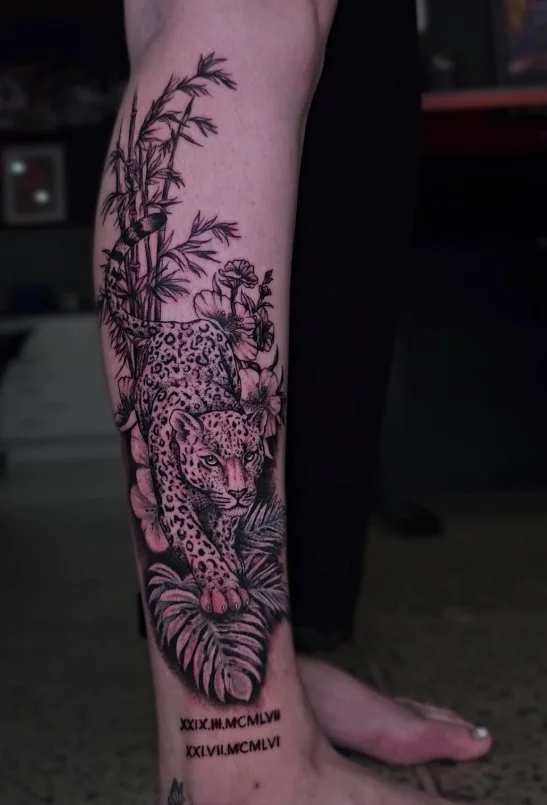 Tropical jungle foliage calf tattoo with layered leaves