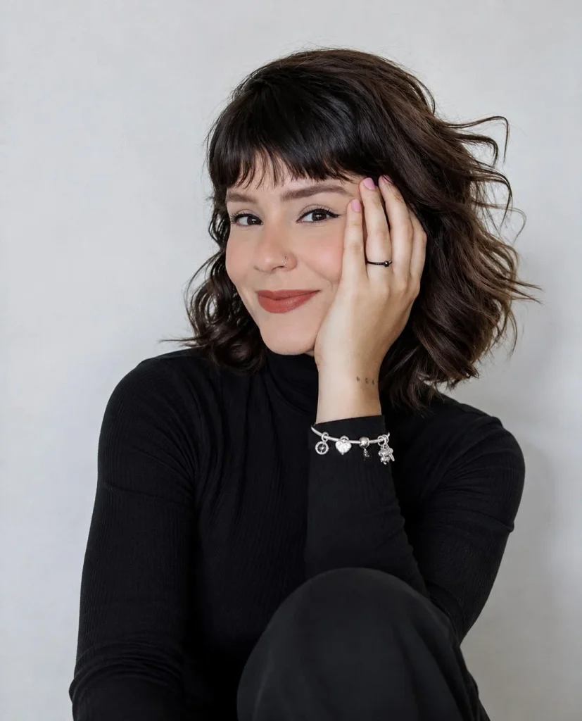 Woman wearing silver Pandora jewelry with an all-black outfit