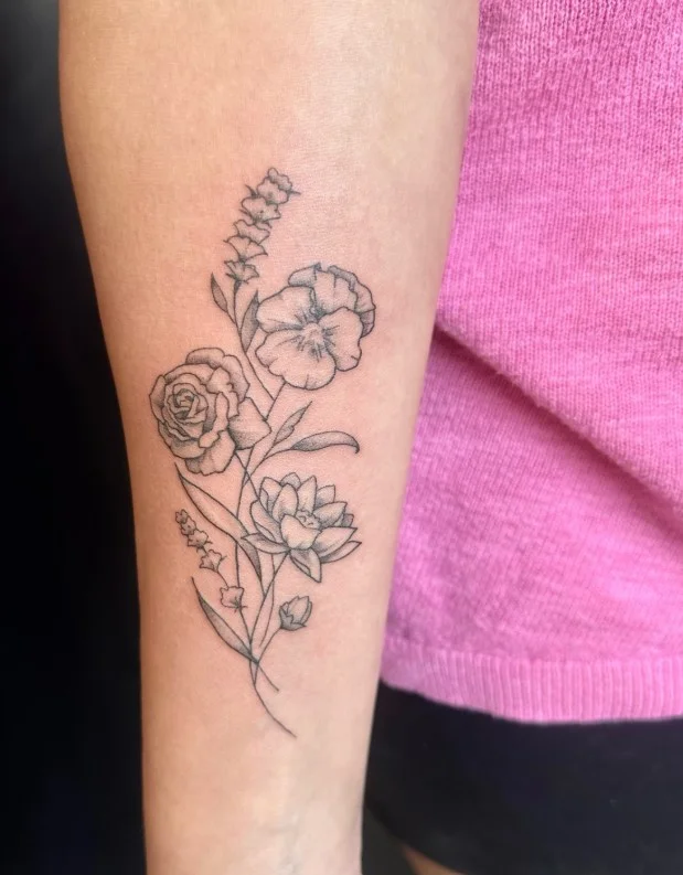 Upper forearm tattoo women birth flower arrangement tattoo