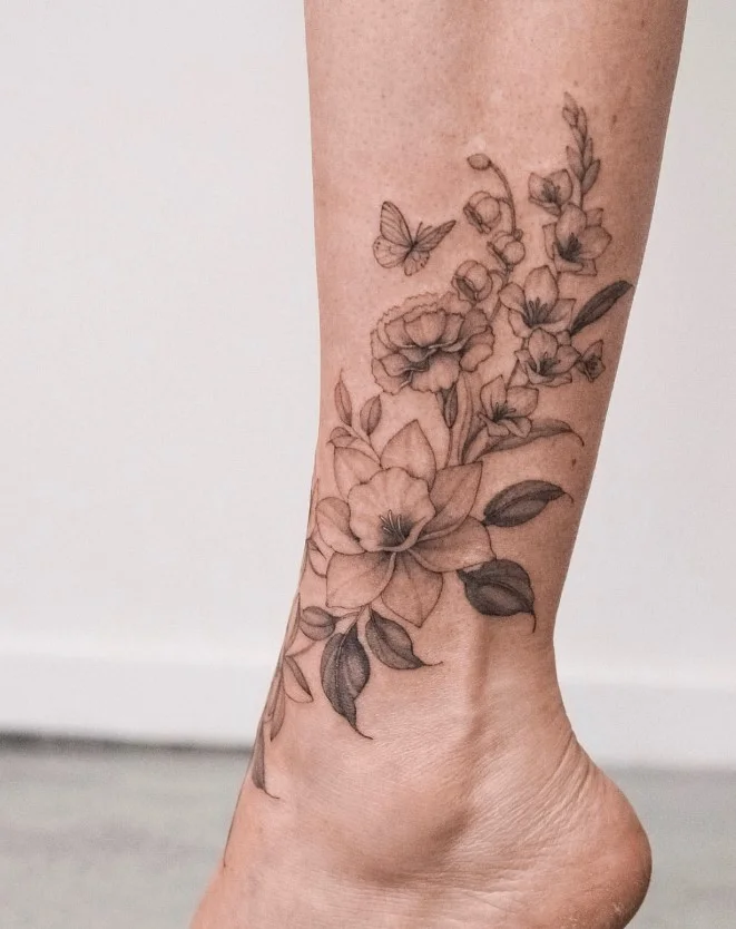 Birth flower lower leg tattoo in an elegant vertical arrangement