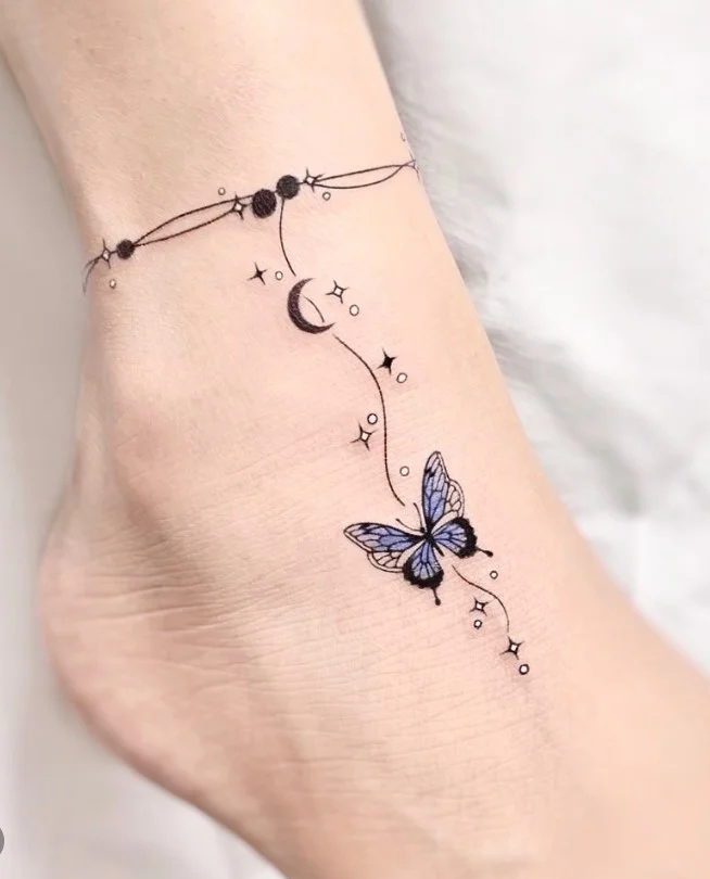 Fine line crescent moon and stars ankle tattoo featuring a small crescent moon surrounded by delicate stars on the outer ankle