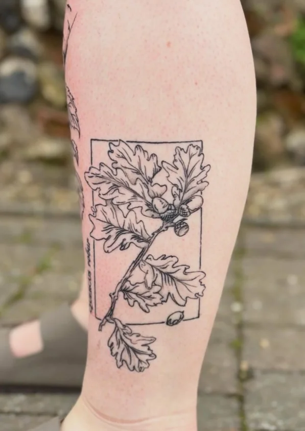 Fine-line botanical branch calf tattoo with delicate leaves and buds
