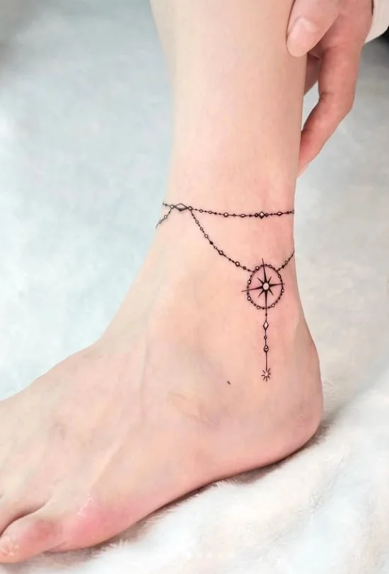 Fine line compass ankle tattoo featuring a small minimalist compass design with clean directional lines on the ankle