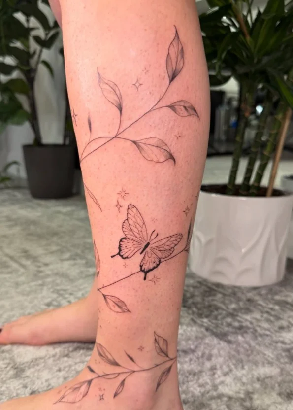 Floral vine calf tattoo flowing naturally along the lower leg