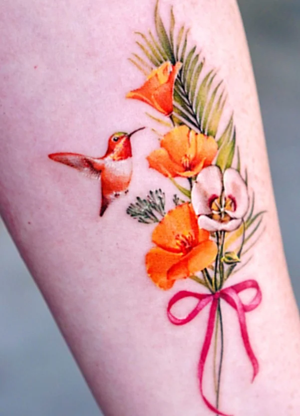 Hummingbird and flower calf tattoo with delicate botanical details