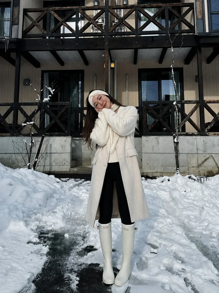 Long coat chunky sweater leggings and Hunter boots