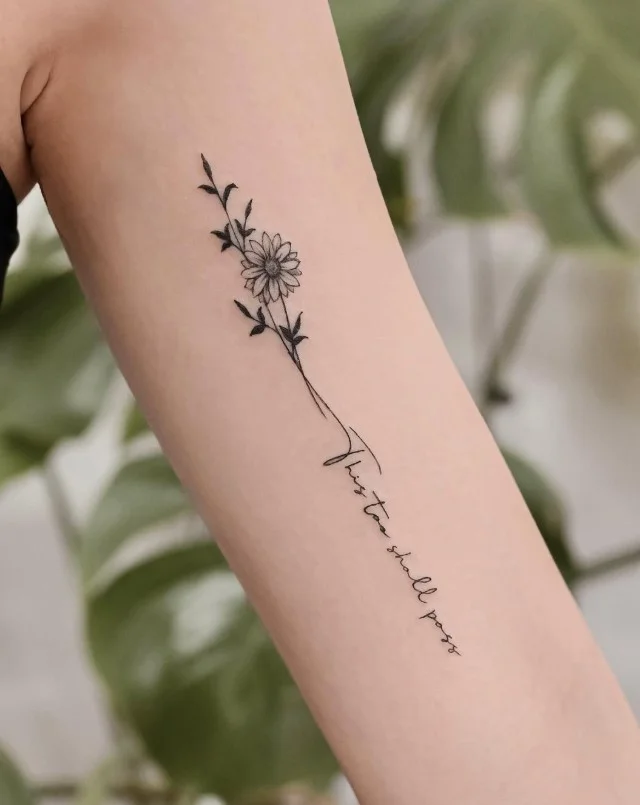 Meaningful handwritten quote tattoo placed vertically on the inner upper arm