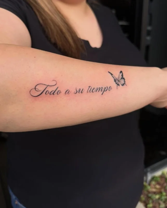 Meaningful quote lettering tattoo placed vertically along the inner forearm