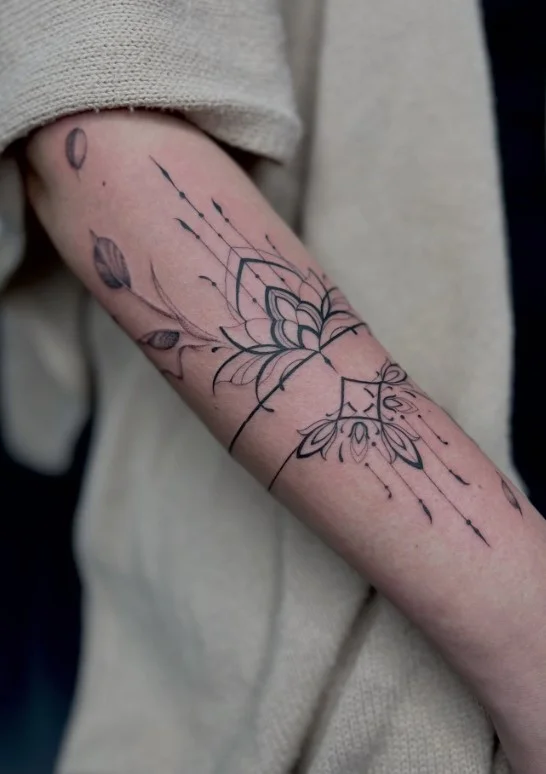 Ornamental tattoo band wrapping around the underside of the forearm