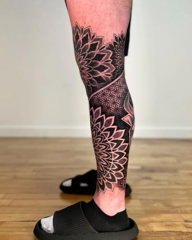 Ornamental mandala calf tattoo with detailed symmetrical linework