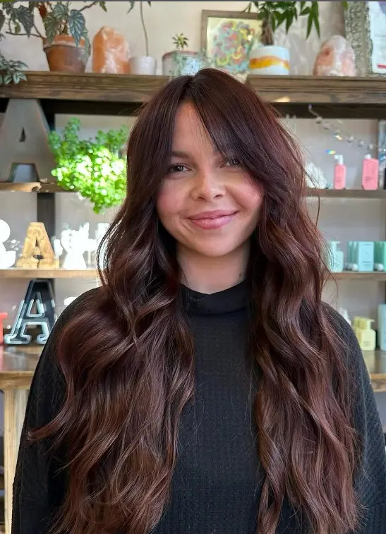 Chocolate cherry brown hair with soft, warm cherry-red reflections.