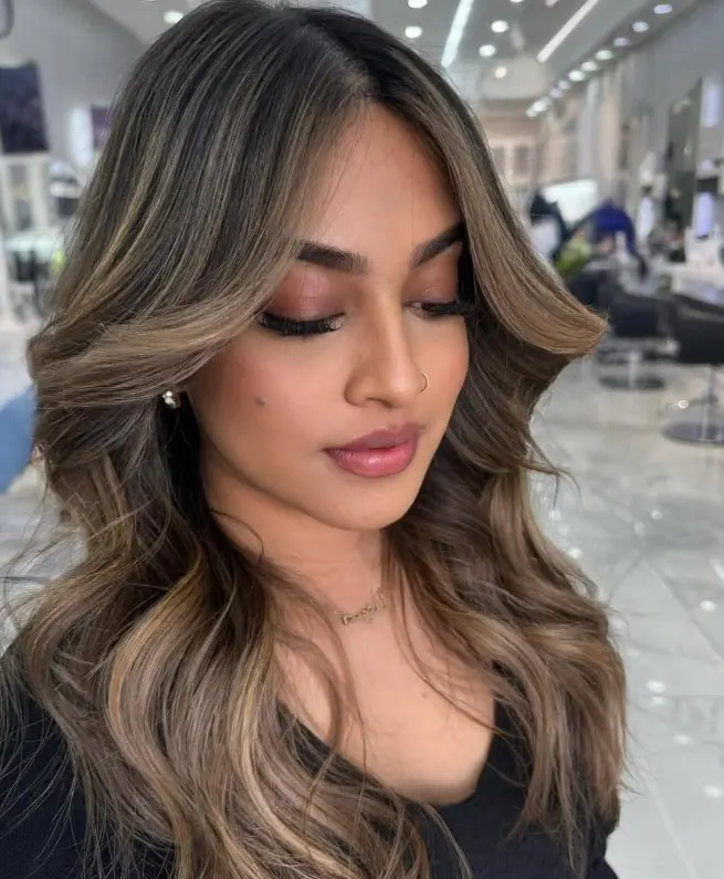 Beige blonde highlights creating neutral contrast against dark brown hair