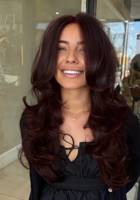 Near-black cherry hair with subtle red-violet tones visible in the light.