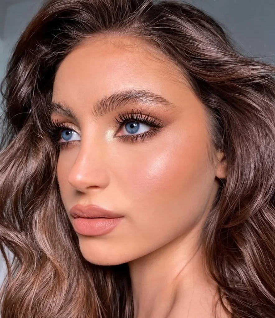 Woman with blue eyes wearing brown-black mascara for softly defined lashes