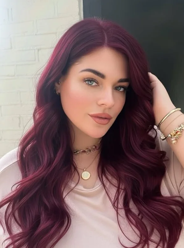 Deep burgundy hair featuring rich wine-red and berry tones for a dramatic color transformation.