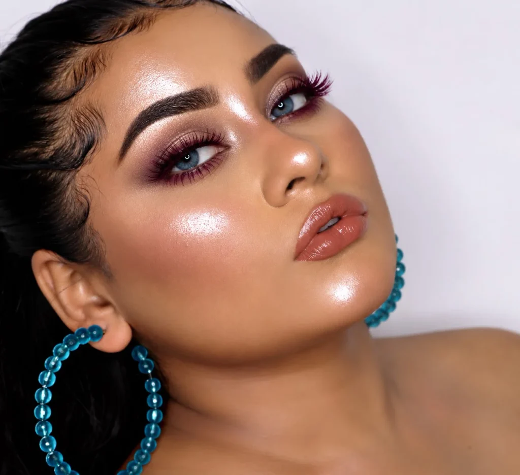Woman with blue eyes wearing rich burgundy mascara for a warm, defined lash look