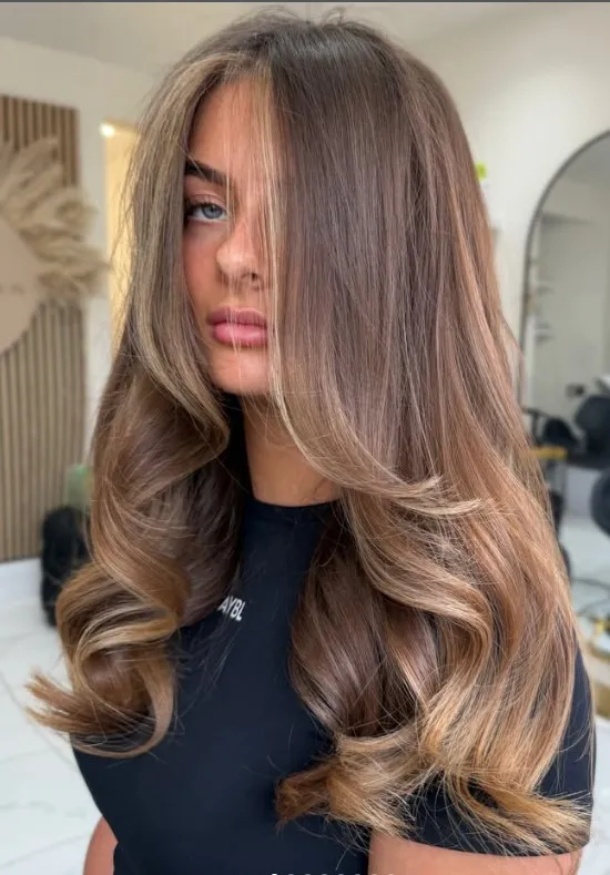 Brown hair with blended caramel balayage highlights through the lengths for warm, sunlit dimension.