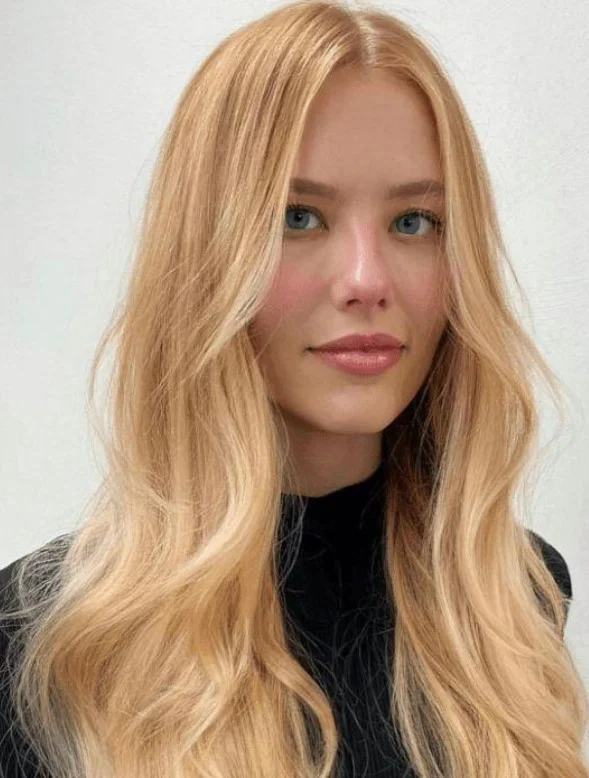Champagne blonde hair in a creamy, light shade with balanced beige and neutral tones.