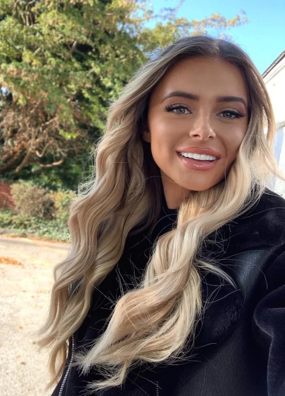 Woman with champagne blonde hair in a creamy, light blonde shade with balanced neutral tones and a luminous finish.
