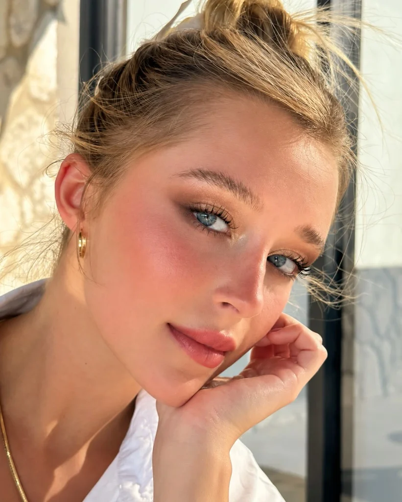 Blue eyes featuring luminous champagne eyeshadow on the lids with warm taupe blended softly through the crease.