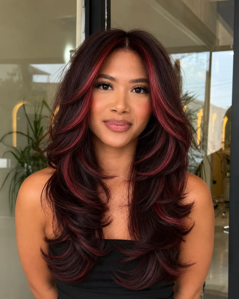 Cherry-red face-framing highlights against a dark brown hair base.