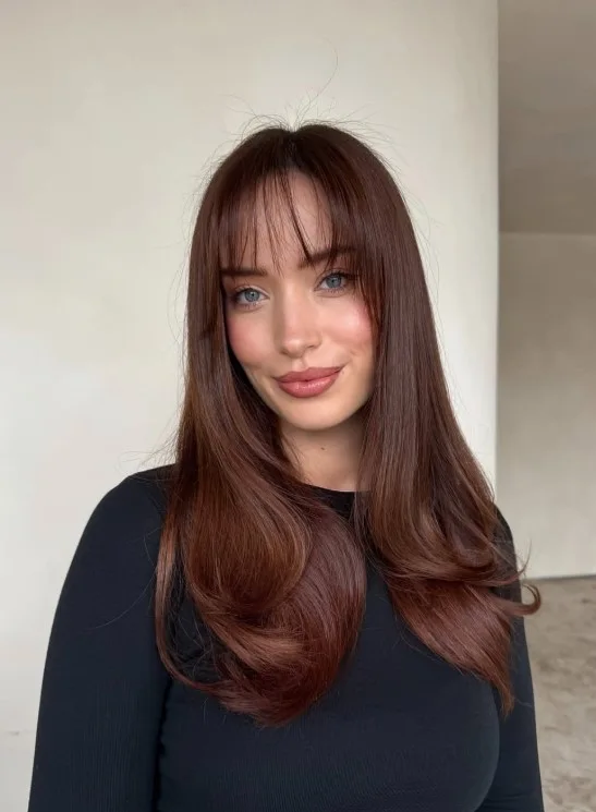 Chestnut brown hair with warm reddish-brown reflections and rich brunette dimension.