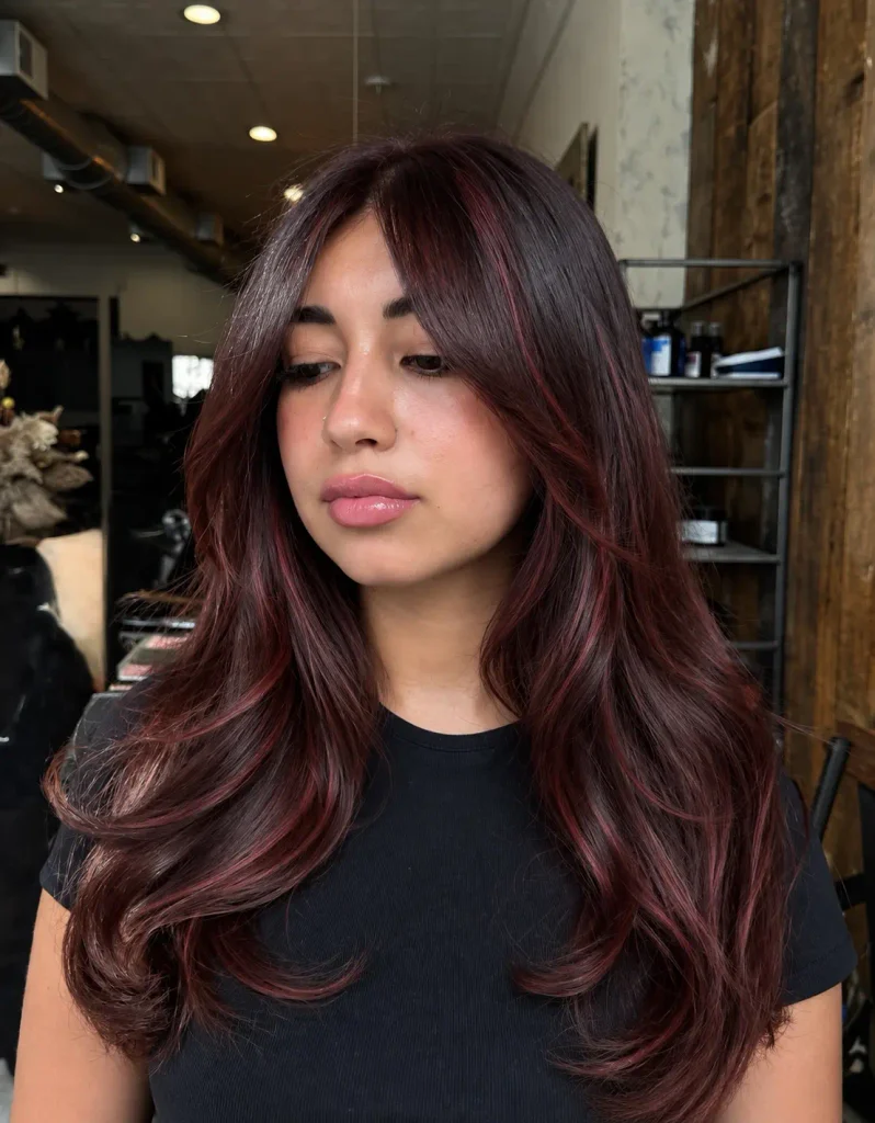 Bold cherry-red highlights contrasting with chocolate brown hair