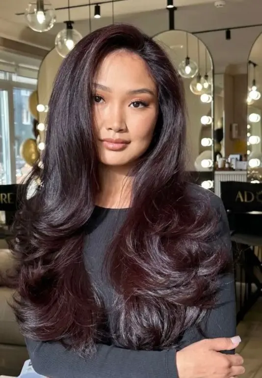 Chocolate cherry hair with warm brown tones and soft burgundy reflections