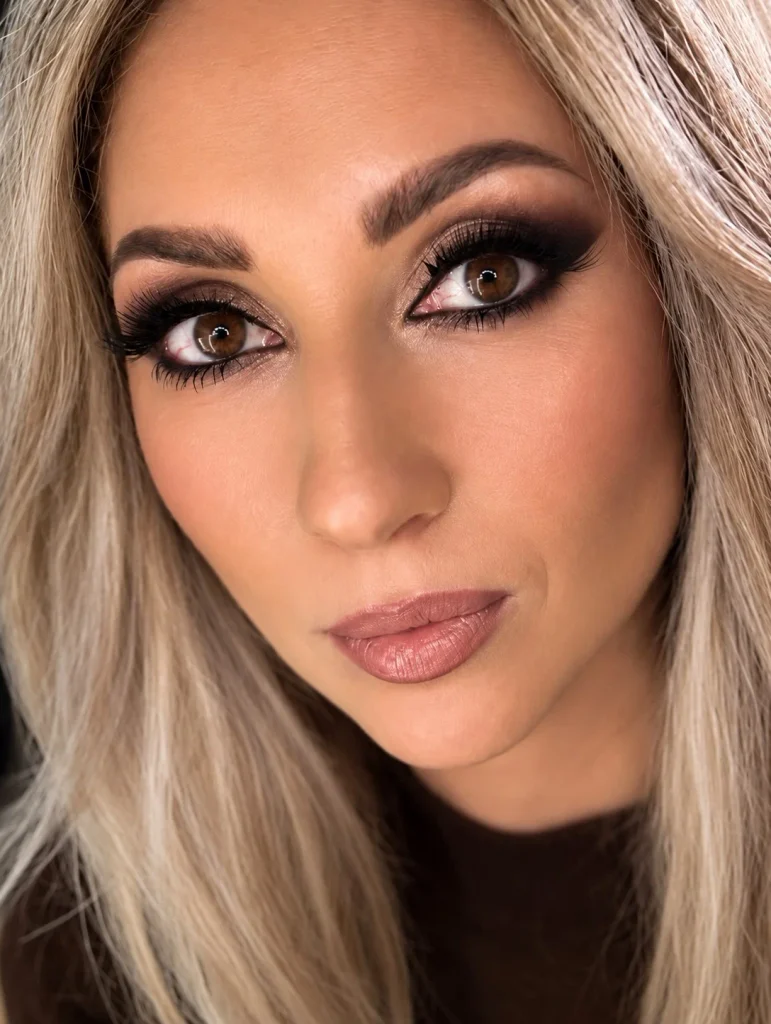 Woman with brown eyes wearing classic black mascara for defined dark lashes