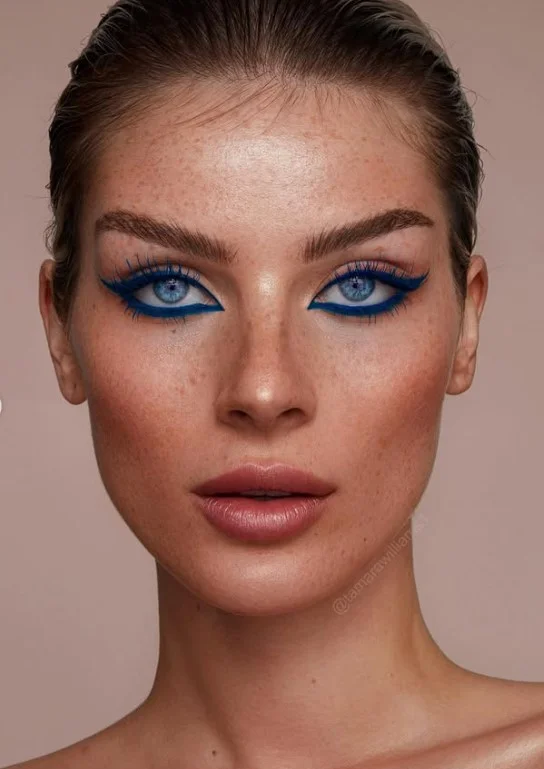 Woman with blue eyes wearing bright cobalt blue mascara for a bold colorful lash look