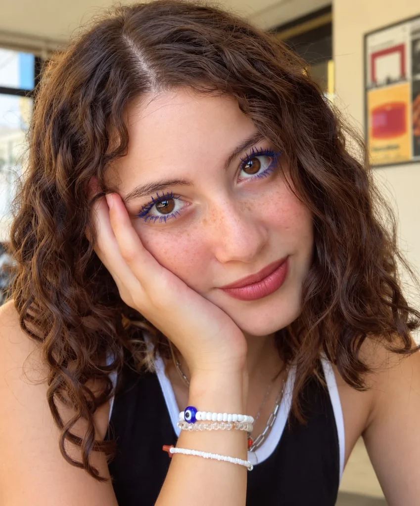 Woman with brown eyes wearing vivid cobalt blue mascara for a bold colorful lash look