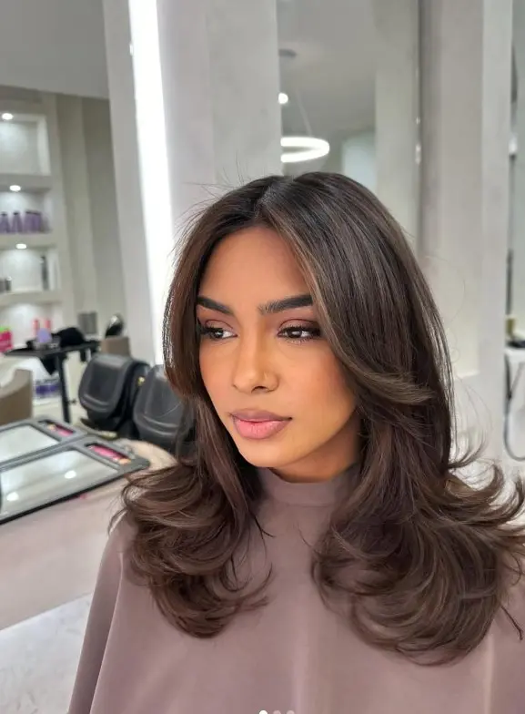 Cool ash brown highlights blended into dark brunette hair
